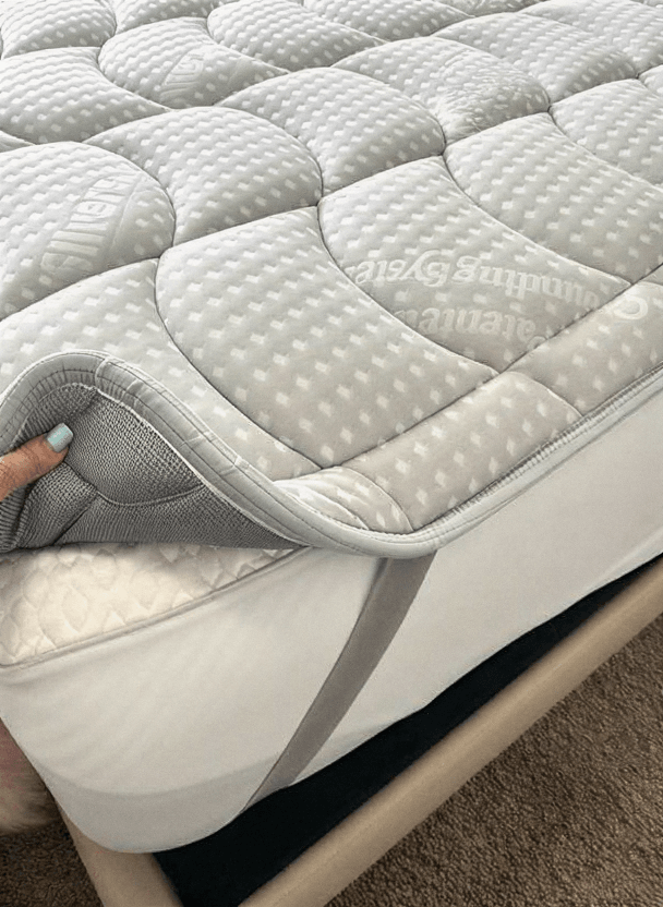 Close-up of the Grounding Topper being lifted off a mattress corner