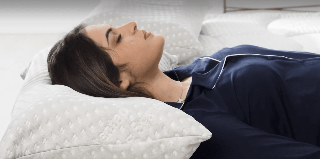 Woman sleeping deeply on a grounding pillow and mattress